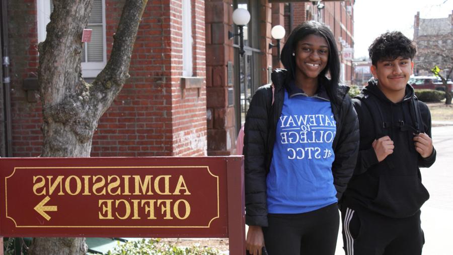 Gateway to College students with Gateway T-shirt next to Admissions Office sign